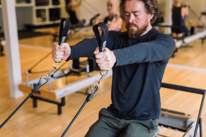 Reformer Pilates instructor Jeremy Wilkerson teaches a class at Rocksteady Bodyworks in Holladay, Utah.