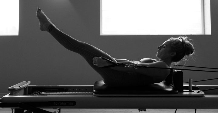 A woman participates in a reformer pilates class at Rocksteady Bodyworks in Holladay, Utah. 