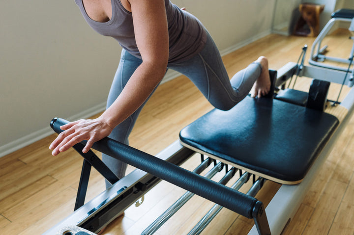 A woman taking a reformer pilates class at Rocksteady Bodyworks in Holladay, Utah