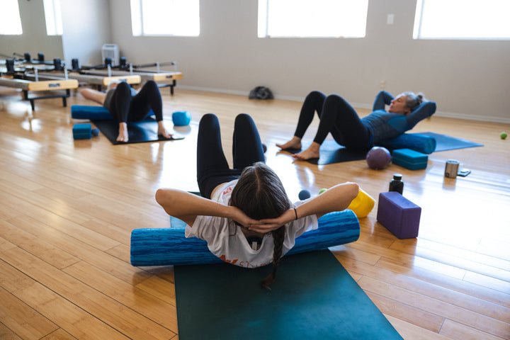 Students participate in a restorative roll and release class at Rocksteady Bodyworks in Holladay, Utah.